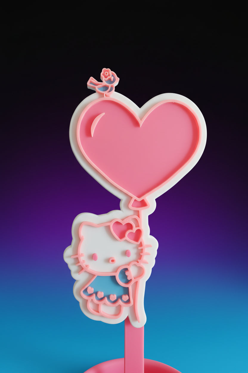 Hello Kitty headphone stand with black headphones on a desk
