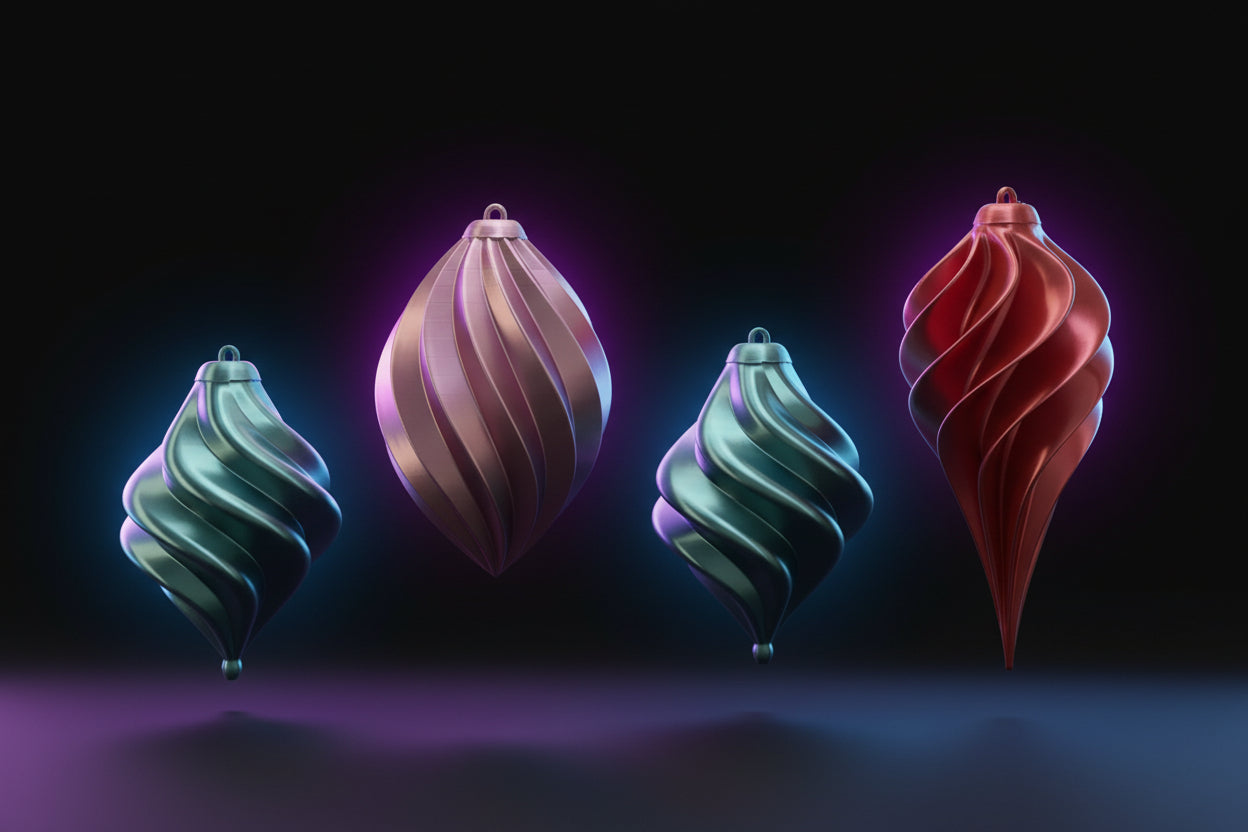 Teal, pink, and red holiday vase mode ornaments hanging on a pine tree