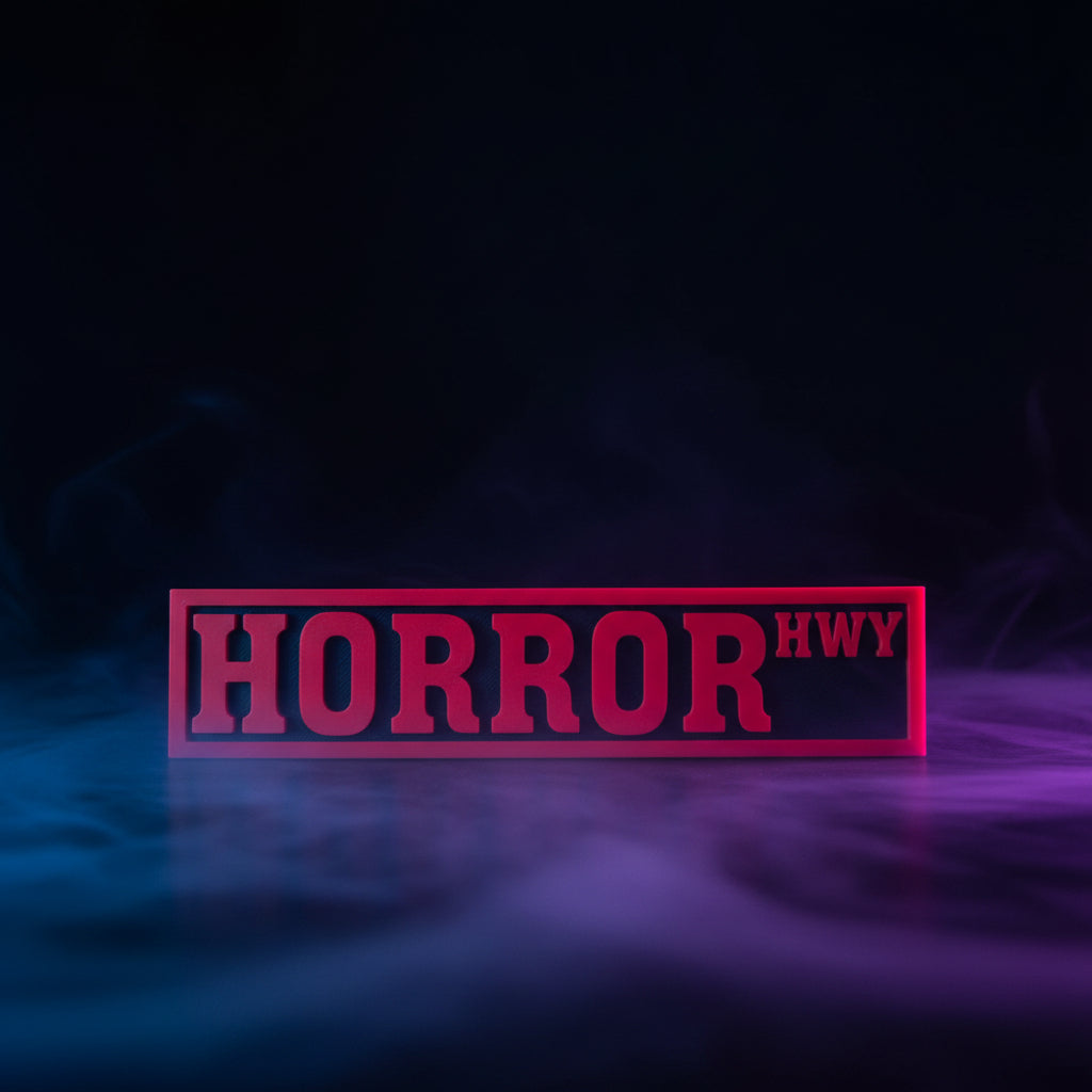 3D printed Horror Hwy street sign in red and black displayed in front of Fourth Wing and other BookTok books on a shelf