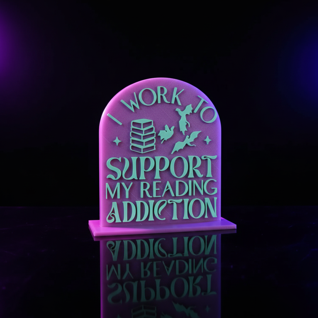 I Work To Support My Reading Addiction bookshelf sign styled on a shelf with dark fantasy books and a black crystal skull