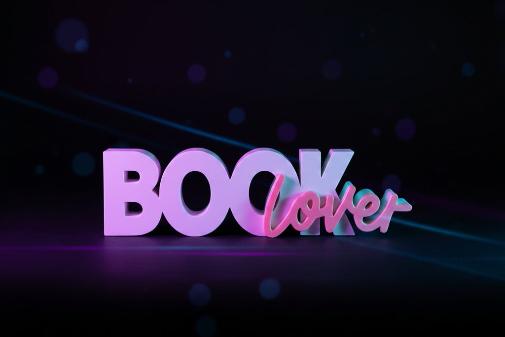 Front view of 3D printed Book Lover sign with white block letters and pink script