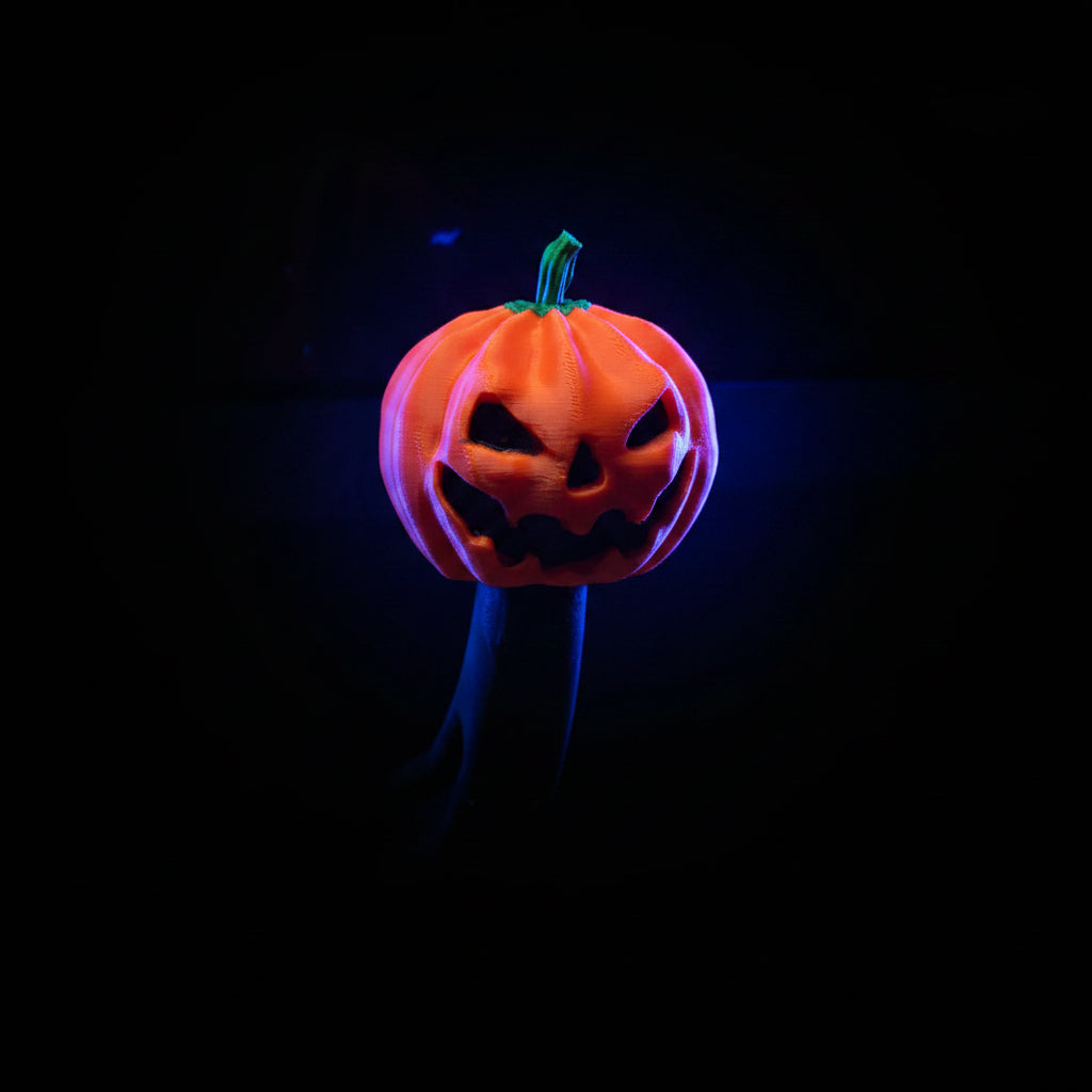 3D printed orange jack-o'-lantern pumpkin tow hitch cover on a truck hitch — lifestyle shot