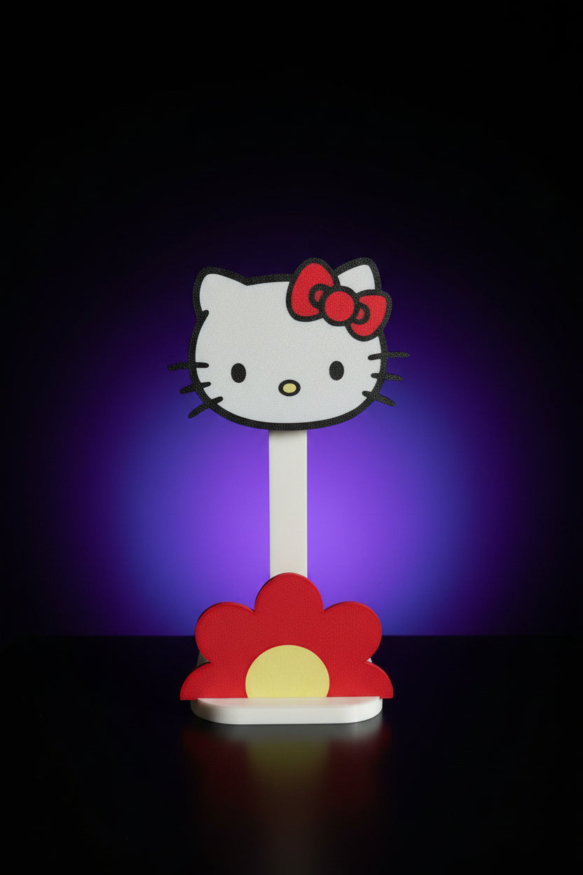 Close-up of Hello Kitty face headphone stand showing glitter outline, red bow, and red flower base